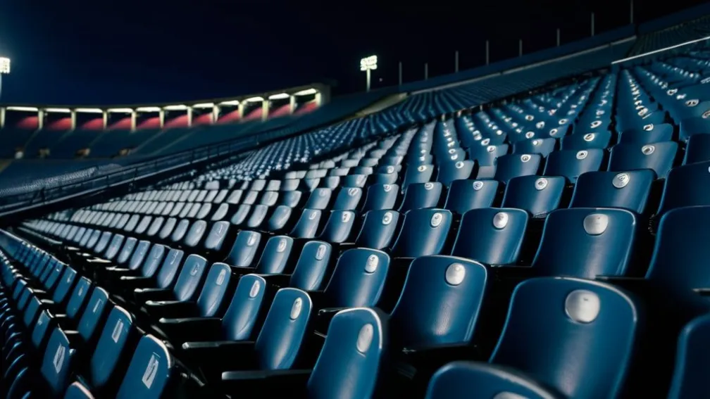 Пустые сиденья стадиона в сумерках, одинокий упавший шарф, торжественная атмосфера, кинематографическое освещение, 8k, гиперреалистично.